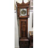 A late 18thC and later oak longcase clock with pokerworked ornament,