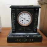 A late Victorian black slate cased mantel clock of architectural form;