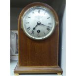 An Edwardian string inlaid mahogany round cased mantel clock;