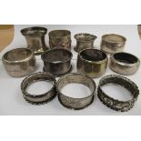 Eleven silver and silver coloured metal napkin rings of varying forms mixed marks 11