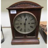 An early 20thC mahogany cased bracket clock with a round arched top and straight sides,