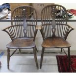 A pair of late 19thC beech and elm framed wheel, hoop and spindled back, Windsor arm chairs,