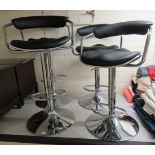 A set of four modern height adjustable bar stools,