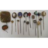 A collection of yellow metal and other stickpins: to include a cameo; a 15ct gold flowerhead;