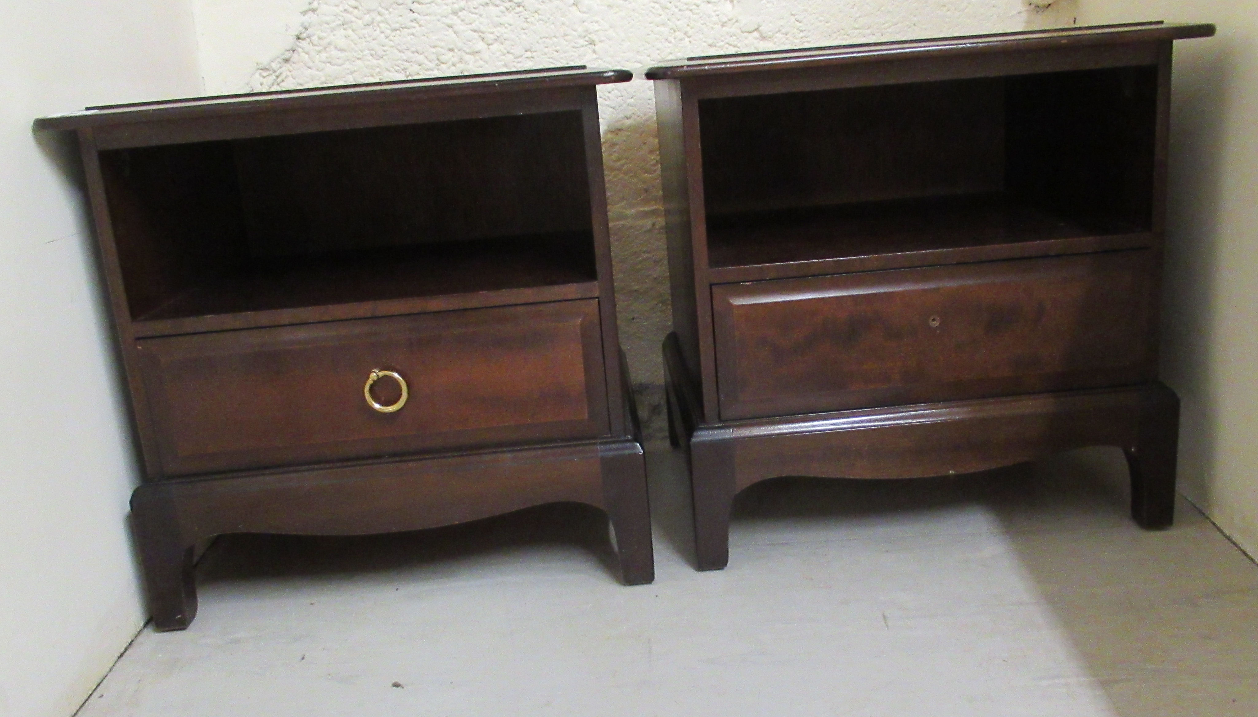 A pair of 20thC Stag mahogany bedside chests, each with an open shelf, over a long drawer,