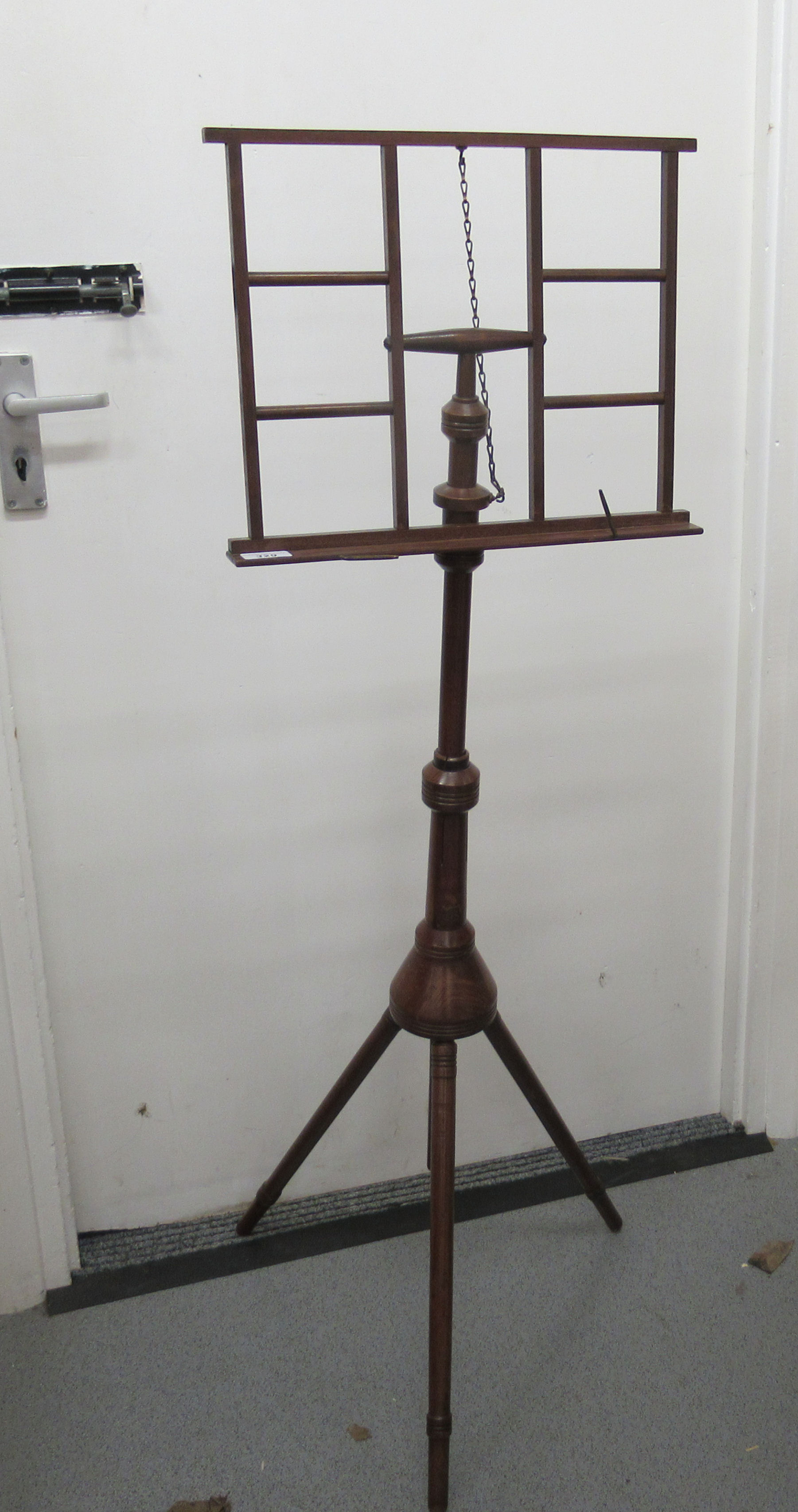 A 20thC mahogany and stained beech music stand,