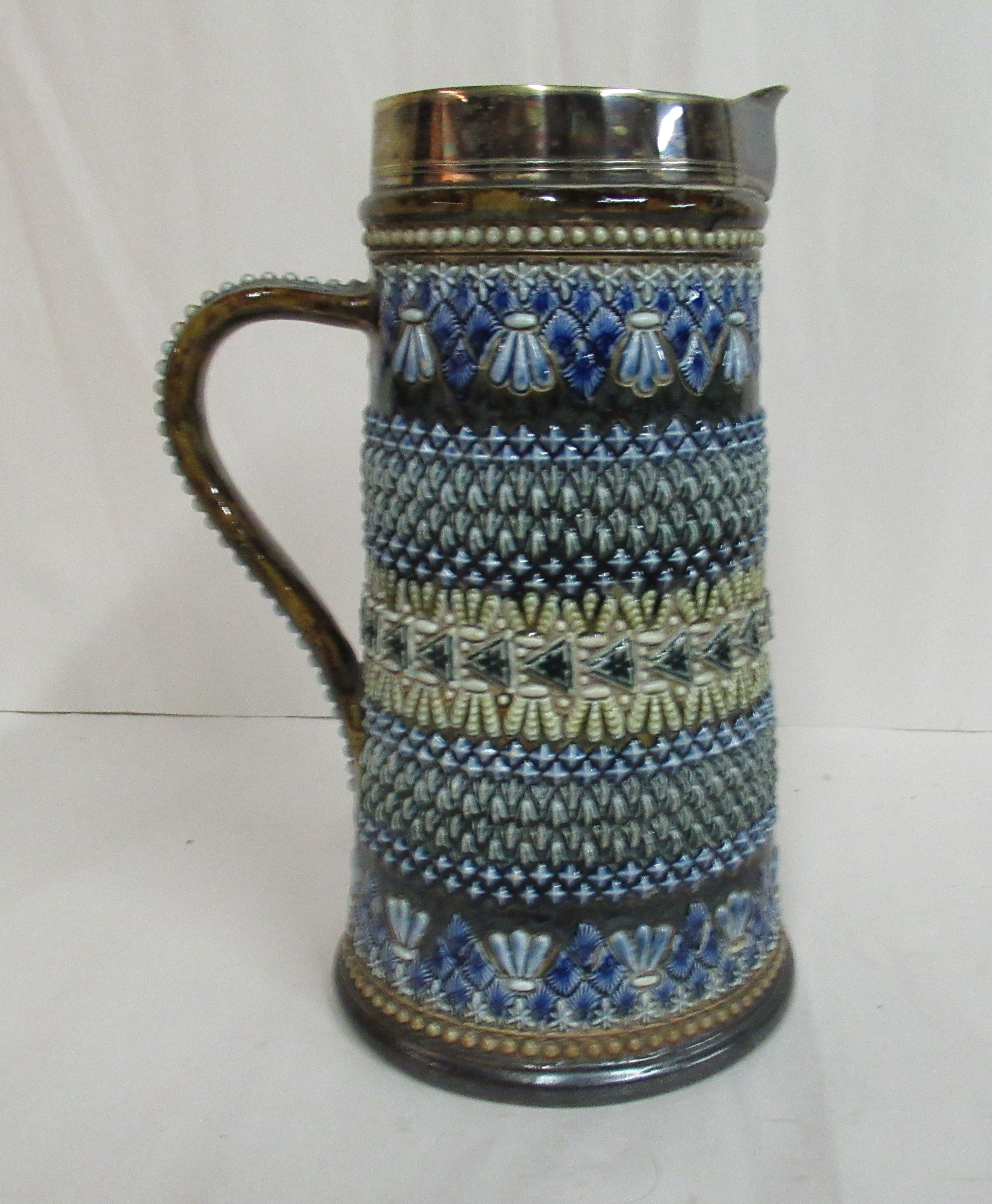 A Doulton Lambeth stoneware jug of tapered, cylindrical form,