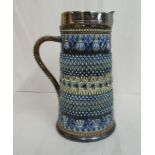 A Doulton Lambeth stoneware jug of tapered, cylindrical form,