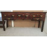 An early 18thC oak dresser with a planked top, over three, deep,