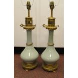 A pair of modern celadon glazed china and lacquered brass mounted table lamps,