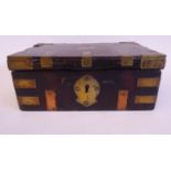 A 19thC Continental hardwood casket with riveted brass mounts, flank handles,