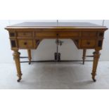 A late 19th/early 20thC light oak, five drawer, kneehole desk with a gilded black hide scriber,