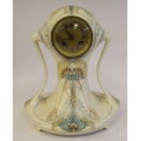 An Arnhem Art Nouveau cream coloured fiance earthenware cased mantel clock of waisted oval form