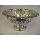 A late Victorian silver rose bowl, having a downturned rim and elevated on a domed, pedestal foot,