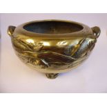 An early 20thC Japanese bronze centrepiece fish bowl of shallow, bulbous form,