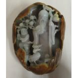 A Chinese double sided, carved jade ornament, featuring a sage with a boy at his side,