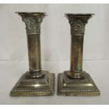 A pair of Edwardian loaded silver candlesticks,