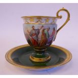 An early 20thC Vienna porcelain pedestal cup and saucer with a scrolled handle,