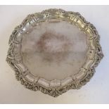 An Edwardian silver waiter with a raised, foliate cast piecrust border,