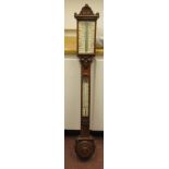A late Victorian light oak cased stick barometer with roundel, anthemion and shell carved ornament,