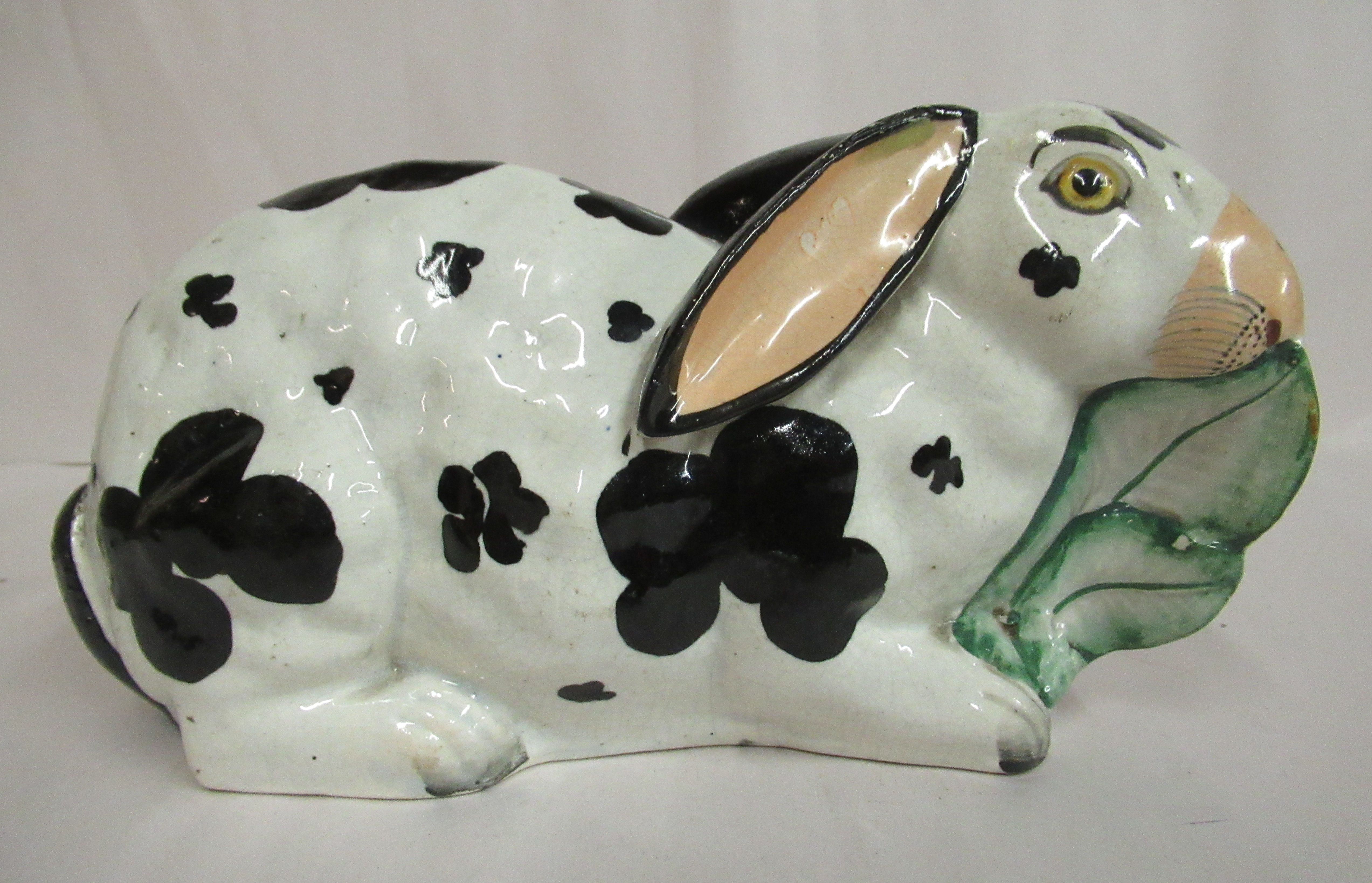 A mid 19thC Staffordshire pottery model, a seated rabbit with black on white markings,