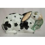 A mid 19thC Staffordshire pottery model, a seated rabbit with black on white markings,