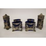 An Art Nouveau six piece silver framed condiments set with blue glass liners,