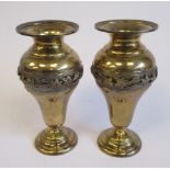 A pair of silver gilt pear shaped pedestal vases with narrow necks and a cast frieze of trailing,