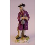 A mid 19thC Continental porcelain figure, a standing merchant, wearing a tricorn hat, wig,