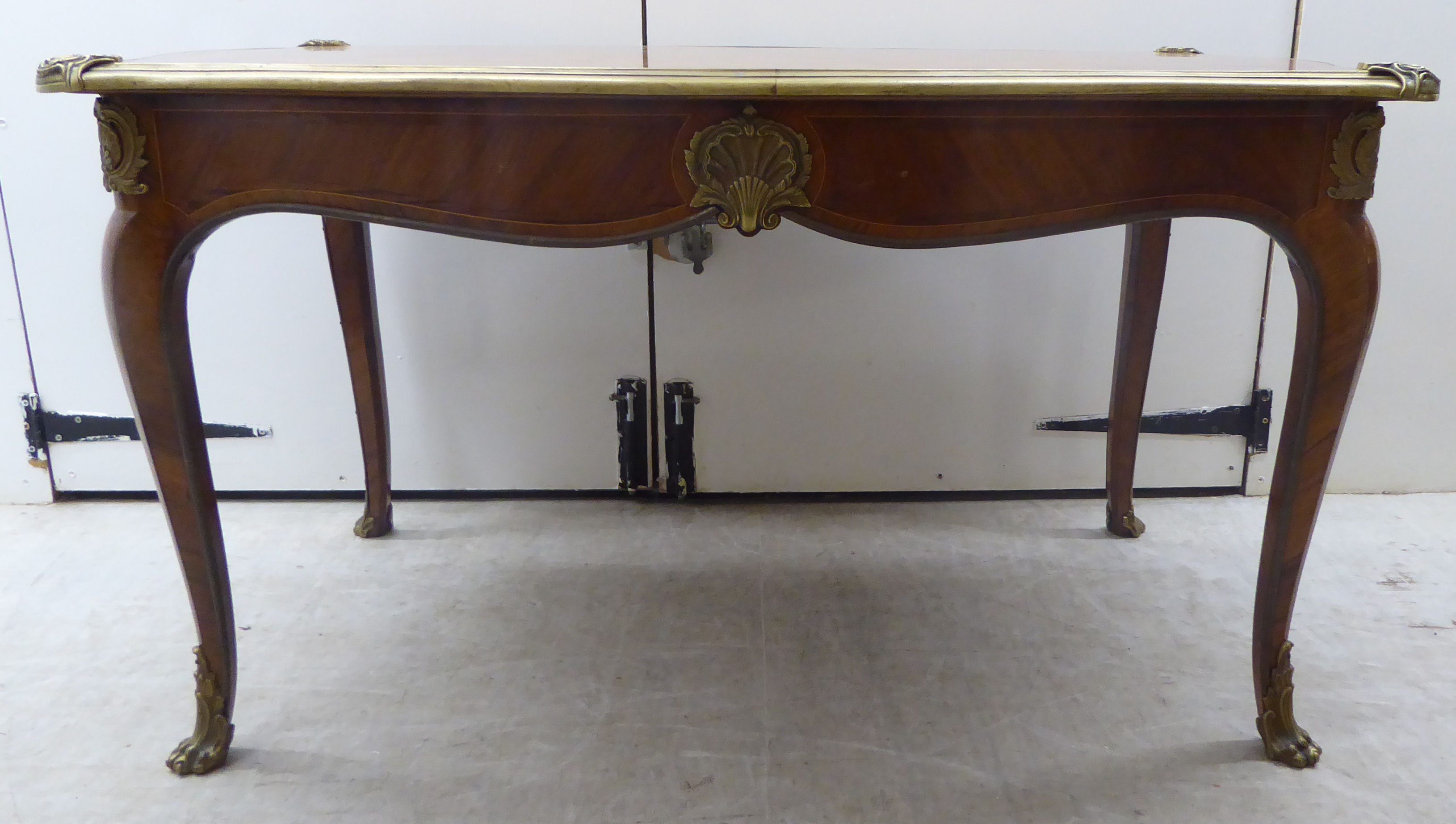 A Louis XV inspired kingwood and parquetry serpentine outlined table with gilt metal mounts,