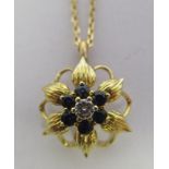 An 18ct gold floral pendant, set with a diamond and sapphires,