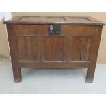 An early 18thC tri-panelled oak coffer with looped wire hinges and an iron hasp for the lock,