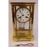 A late 19thC/early 20thC French lacquered brass cased four glass mantel clock,