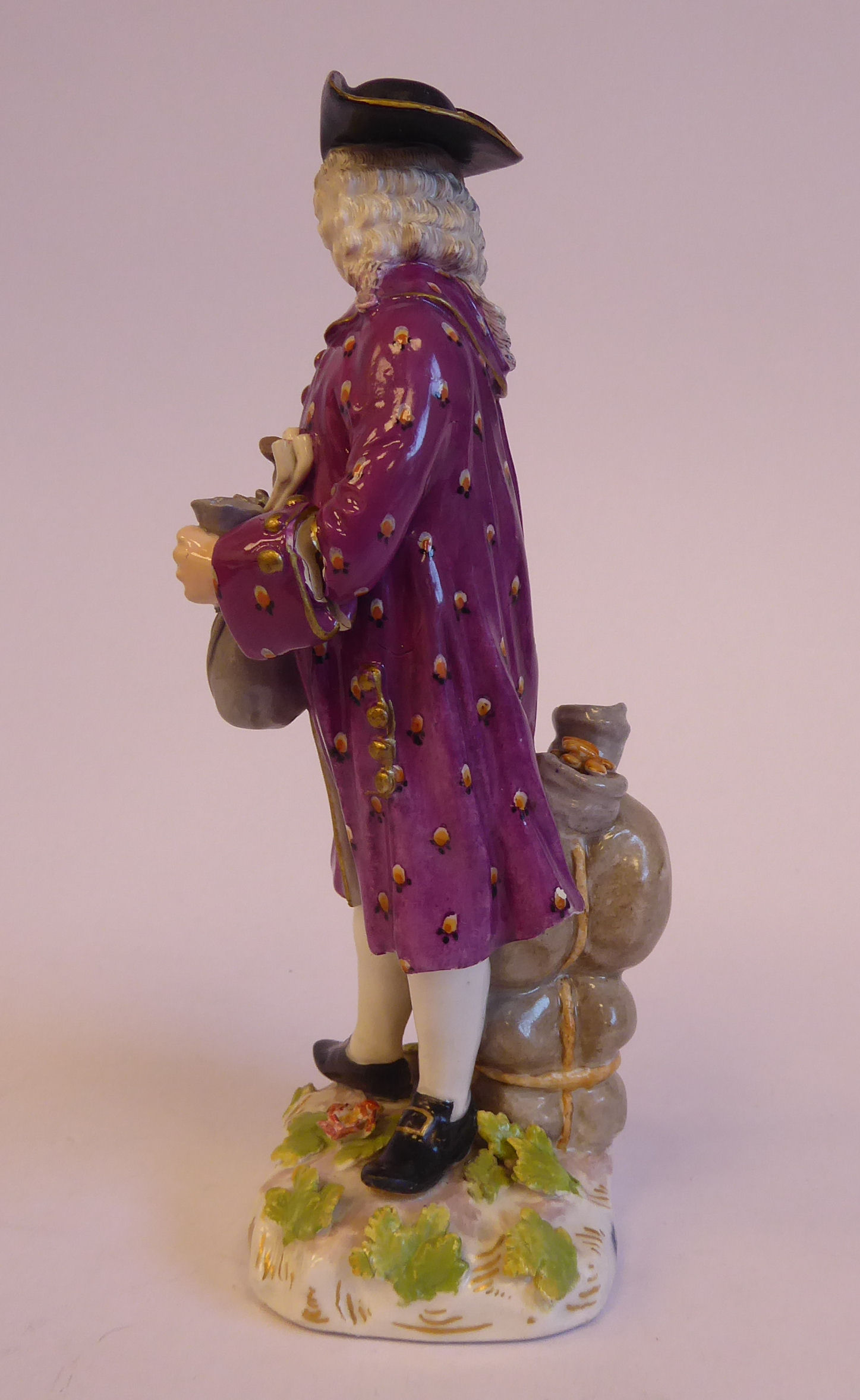 A mid 19thC Continental porcelain figure, a standing merchant, wearing a tricorn hat, wig, - Bild 4 aus 7