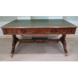 A 19thC design mahogany desk with a tooled and gilded, bottle green hide scriber,
