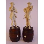A pair of 19thC carved Dieppe ivory figures, itinerant musicians, each wearing a hat,