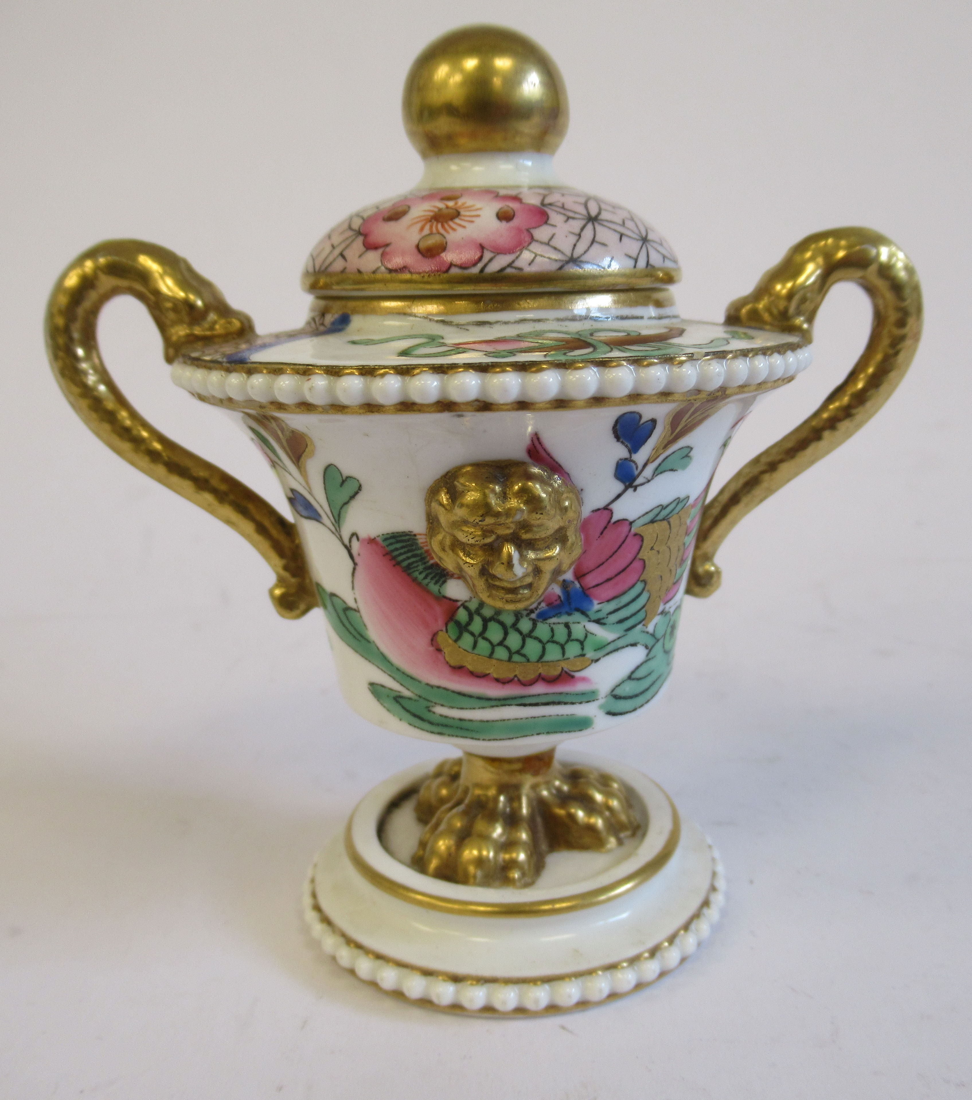 A 19thC porcelain gilded and painted, mask decorated,