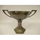 A silver octagonal angular twin loop handled shallow bowl, elevated on a conforming,