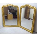 A pair of Louis-Philippe inspired round arched mirrors, set in wide, bead bordered,