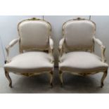 A pair of Louis XV inspired carved and gilded, cream coloured,