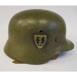 A World War II German khaki coloured steel helmet with two decals,