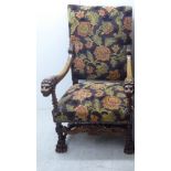 A baronial style, carved mahogany framed throne chair, having a high, level back, open,