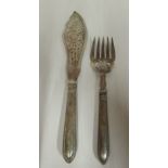 A pair of late Victorian silver fish servers with decoratively pierced and engraved ornament,