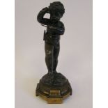A late 19thC cast and patinated gilt bronze dancing cherubic figure, playing a musical instrument,