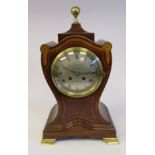 An Edwardian mahogany waisted shield shaped mantel clock with satinwood marquetry and string inlaid