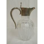 A late Victorian diamond and slice cut glass baluster shaped wine jug with an applied silver collar,