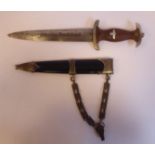 A German SS dagger, the moulded brown handgrip with spreadeagle and swastika emblems,