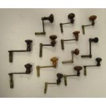 Thirteen various crank design clock keys with turned wooden handles