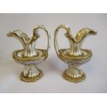 A pair of Copeland Garrett Felspar porcelain ewers with bowl shaped bodies and drawn loop handles,
