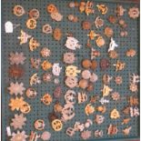 Nearly one hundred military cap badges and other insignia, some copies: to include The Hampshire,